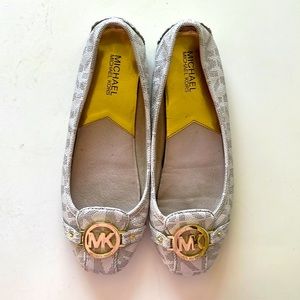 Beautiful cream colored Michael Kors flats with gold detailing.